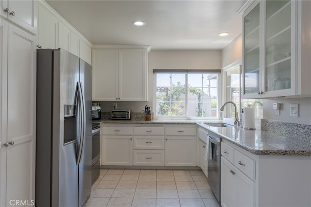 2247 Stratford Way, La Verne, CA 91750 - kitchen featuring appliances with stainless steel finishes, white cabinets, glass insert cabinets, light tile patterned flooring, and light stone countertops