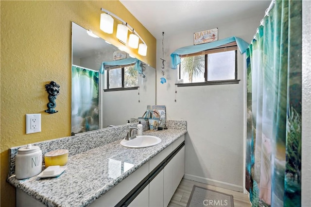 30451 San Pasqual Rd, Temecula, CA 92591 - full bathroom featuring vanity, wood finished floors, and a textured wall