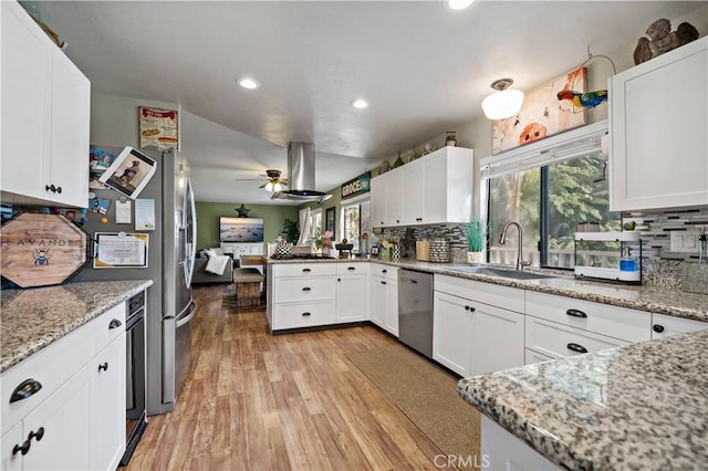 30451 San Pasqual Rd, Temecula, CA 92591 - kitchen featuring stainless steel dishwasher, light wood-style flooring, decorative backsplash, white cabinets, and a peninsula