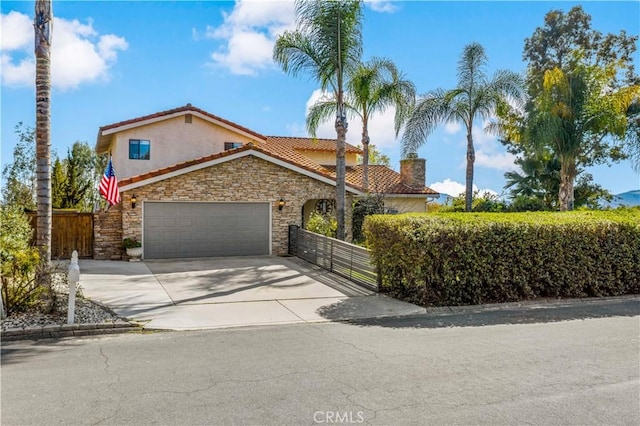 30451 San Pasqual Rd, Temecula, CA 92591 - mediterranean / spanish-style home featuring stone siding, stucco siding, concrete driveway, a tile roof, and a chimney