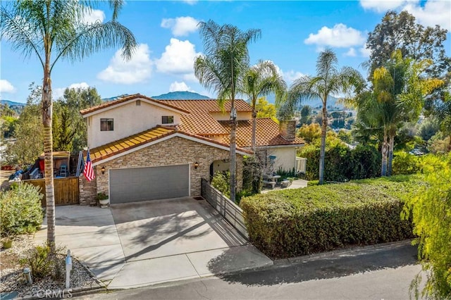 30451 San Pasqual Rd, Temecula, CA 92591 - mediterranean / spanish home with stone siding, a tile roof, driveway, and stucco siding