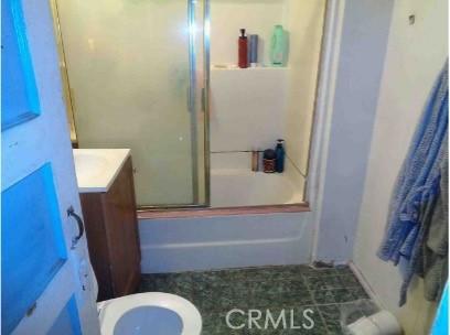 7223 Holmes Ave, Los Angeles, CA 90001 - bathroom featuring vanity and bath / shower combo with glass door
