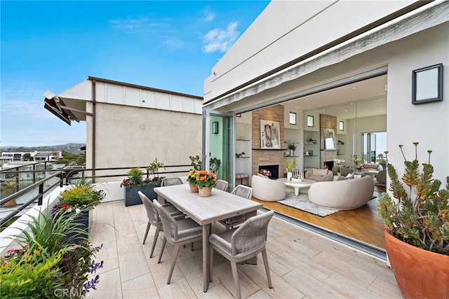 970 Quivera St, Laguna Beach, CA 92651 - patio / terrace featuring a warm lit fireplace and outdoor dining area