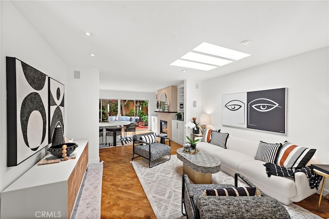 970 Quivera St, Laguna Beach, CA 92651 - living area featuring a skylight, a warm lit fireplace, recessed lighting, and light wood-style floors