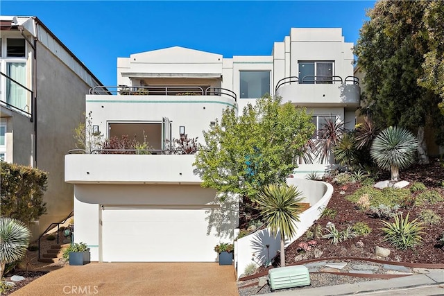 970 Quivera St, Laguna Beach, CA 92651 - art deco inspired home featuring a balcony, an attached garage, driveway, and stucco siding