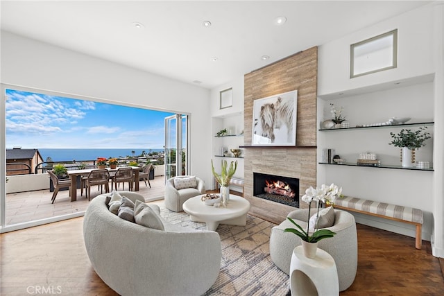 970 Quivera St, Laguna Beach, CA 92651 - living area featuring built in shelves, a high end fireplace, recessed lighting, and wood finished floors