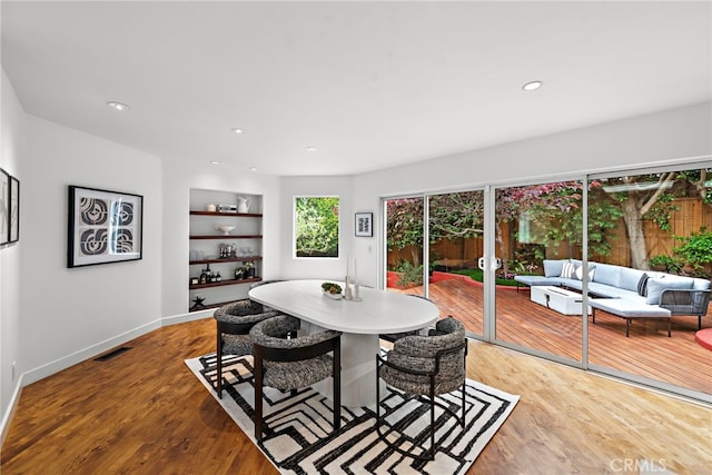 970 Quivera St, Laguna Beach, CA 92651 - dining room with built in shelves, wood finished floors, and recessed lighting