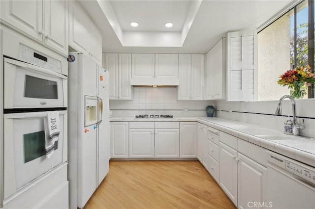 1917 Via Estudillo, Palos Verdes Estates, CA 90274 - kitchen featuring white appliances, white cabinets, light wood-type flooring, backsplash, and recessed lighting