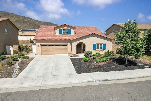 26833 Calico Ct, Winchester, CA 92596 - mediterranean / spanish-style home featuring stucco siding, a tiled roof, concrete driveway, and a mountain view