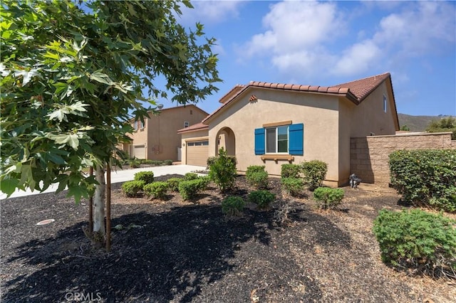 26833 Calico Ct, Winchester, CA 92596 - mediterranean / spanish-style house featuring a garage, stucco siding, a tile roof, and driveway