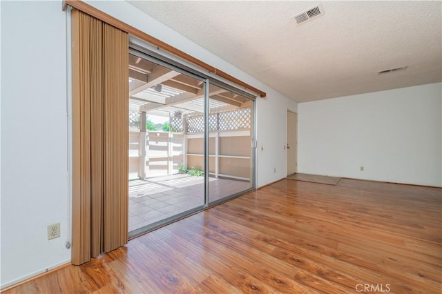 16944 Colchester Way Unit 174, Hacienda Heights, CA 91745 - empty room with wood finished floors and a textured ceiling