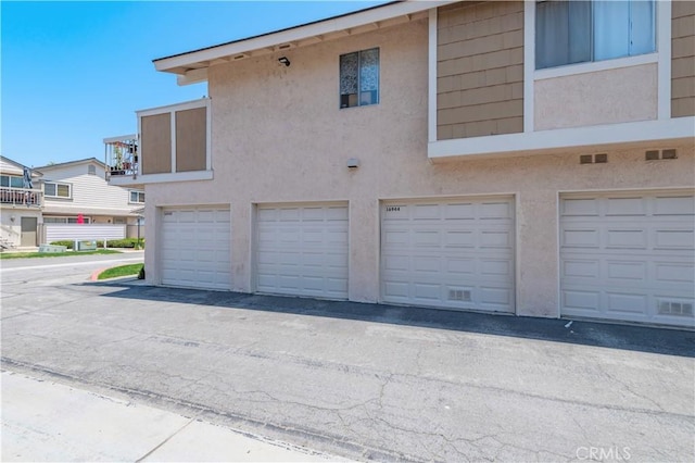 16944 Colchester Way Unit 174, Hacienda Heights, CA 91745 - view of side of property with stucco siding and community garages
