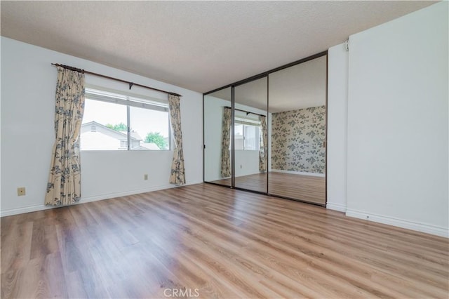 16944 Colchester Way Unit 174, Hacienda Heights, CA 91745 - unfurnished bedroom with light wood-type flooring and a textured ceiling