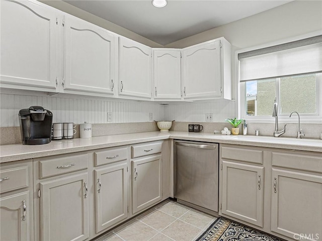 1234 N Pass Ave, Burbank, CA 91505 - kitchen with stainless steel dishwasher, light tile patterned floors, light countertops, and white cabinets