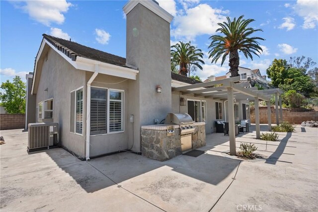 3891 Hunters Grove Ct, Moorpark, CA 93021 - rear view of house featuring area for grilling, a patio, a pergola, and stucco siding