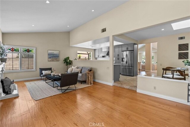 3891 Hunters Grove Ct, Moorpark, CA 93021 - living room featuring lofted ceiling, light wood-style floors, a skylight, and recessed lighting