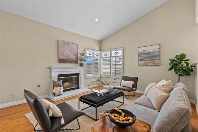 3891 Hunters Grove Ct, Moorpark, CA 93021 - living room with light wood-style flooring, a glass covered fireplace, high vaulted ceiling, and recessed lighting