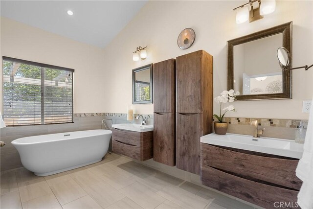 3891 Hunters Grove Ct, Moorpark, CA 93021 - bathroom with a freestanding tub, two vanities, and lofted ceiling