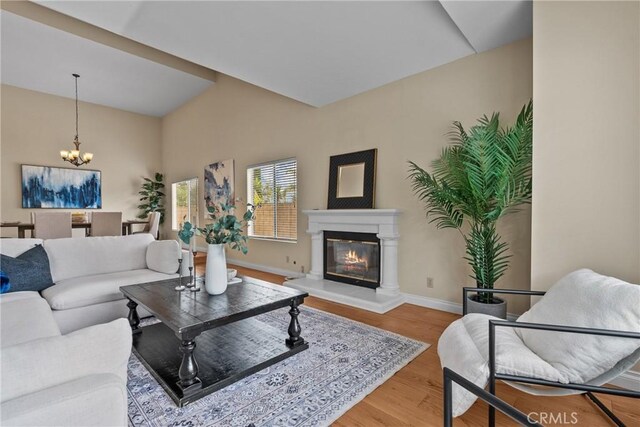 3891 Hunters Grove Ct, Moorpark, CA 93021 - living area featuring a chandelier, wood finished floors, and a glass covered fireplace