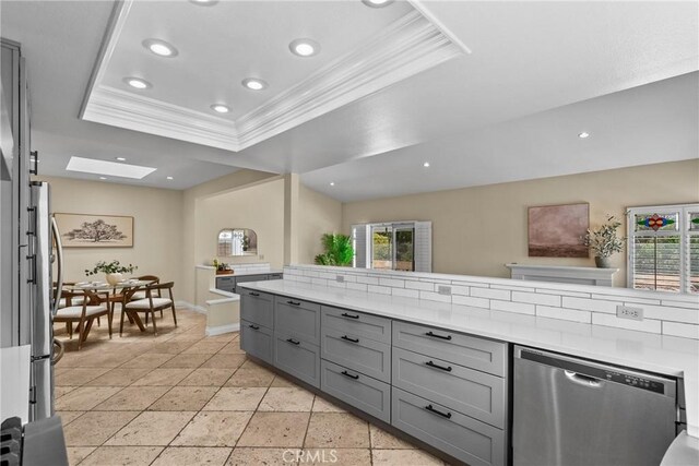 3891 Hunters Grove Ct, Moorpark, CA 93021 - kitchen with stainless steel appliances, gray cabinets, a raised ceiling, crown molding, and plenty of natural light
