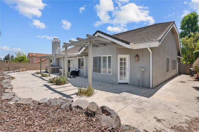 3891 Hunters Grove Ct, Moorpark, CA 93021 - rear view of property featuring a tile roof, a pergola, a chimney, stucco siding, and a fenced backyard