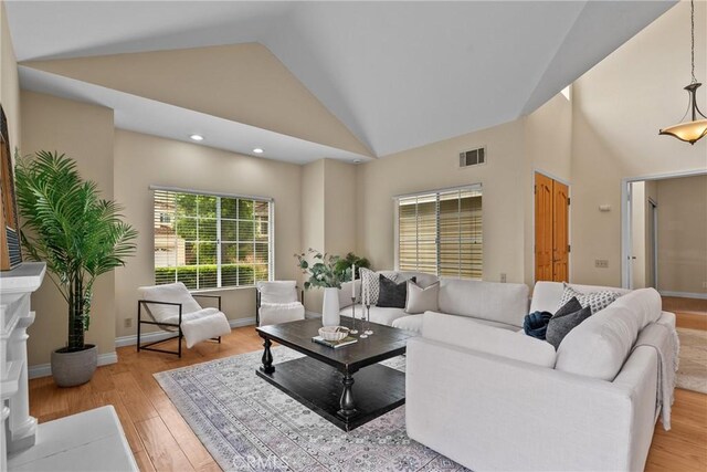 3891 Hunters Grove Ct, Moorpark, CA 93021 - living area featuring light wood-type flooring, high vaulted ceiling, and recessed lighting