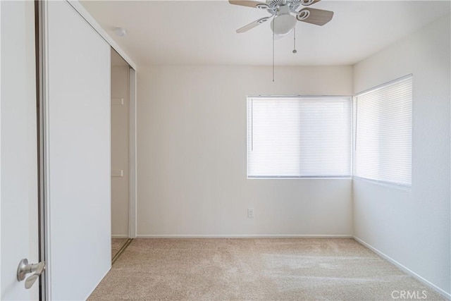 1534 W Summerset Dr, Rialto, CA 92377 - unfurnished bedroom with carpet, multiple windows, and a ceiling fan