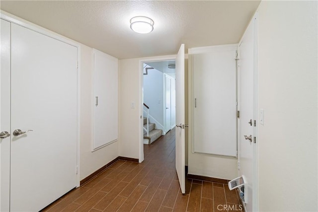 1534 W Summerset Dr, Rialto, CA 92377 - hall featuring stairway, dark wood-style flooring, and a textured ceiling