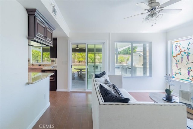 1534 W Summerset Dr, Rialto, CA 92377 - living room with ceiling fan, dark wood-type flooring, and crown molding