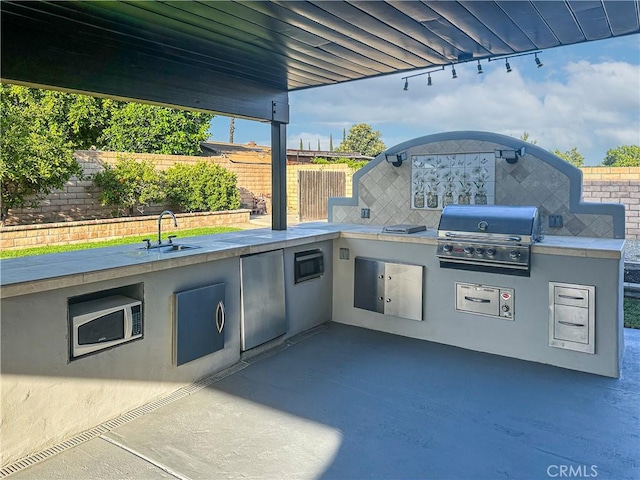 1534 W Summerset Dr, Rialto, CA 92377 - view of patio with exterior kitchen and a sink