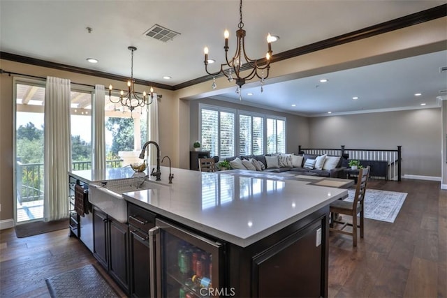 2564 Lunes Ln, Verne, CA 91750 - kitchen featuring a chandelier, wine cooler, open floor plan, ornamental molding, and dark wood-style flooring