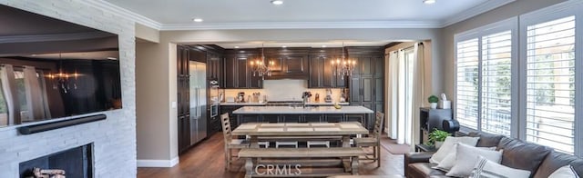 2564 Lunes Ln, Verne, CA 91750 - kitchen featuring dark brown cabinets, light countertops, dark wood-type flooring, an island with sink, and recessed lighting