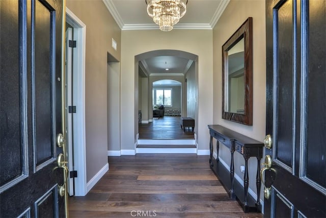 2564 Lunes Ln, Verne, CA 91750 - entrance foyer featuring dark wood-type flooring, arched walkways, ornamental molding, and a chandelier