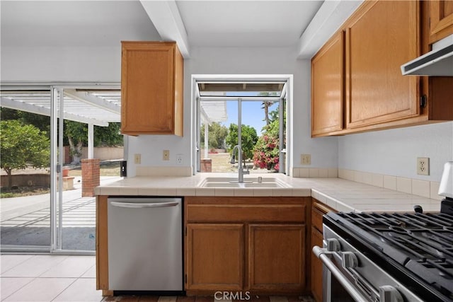 4706 Crestmont Pl, Oceanside, CA 92056 - kitchen featuring stainless steel appliances, under cabinet range hood, and brown cabinets