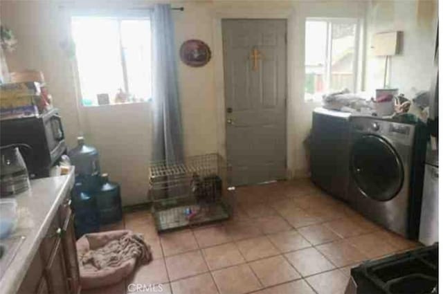 1510 W 65th Pl, Los Angeles, CA 90047 - laundry area featuring washer / clothes dryer, plenty of natural light, and light tile patterned flooring