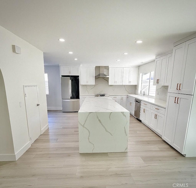 23772 Singapore St, Mission Viejo, CA 92691 - kitchen with stainless steel appliances, wall chimney range hood, a center island, recessed lighting, and light stone counters
