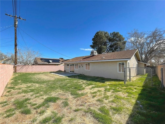 45541 Sancroft Ave, Lancaster, CA 93535 - back of property with stucco siding, a fenced backyard, and a patio