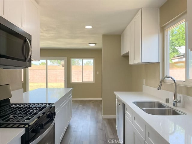 45541 Sancroft Ave, Lancaster, CA 93535 - kitchen featuring appliances with stainless steel finishes, plenty of natural light, recessed lighting, light countertops, and white cabinetry