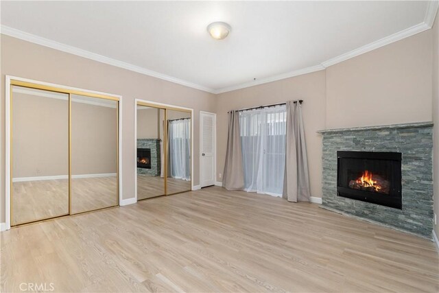 14853 Hartsook St Unit 106, Sherman Oaks, CA 91403 - unfurnished bedroom featuring a stone fireplace, wood finished floors, two closets, and ornamental molding