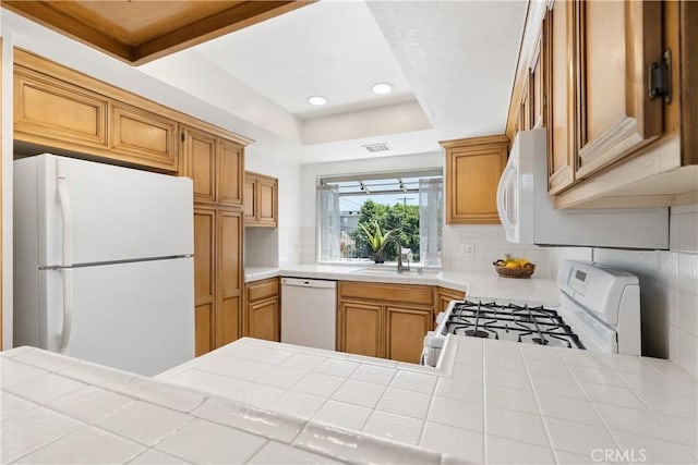 14853 Hartsook St Unit 106, Sherman Oaks, CA 91403 - kitchen with white appliances, backsplash, tile countertops, recessed lighting, and a raised ceiling