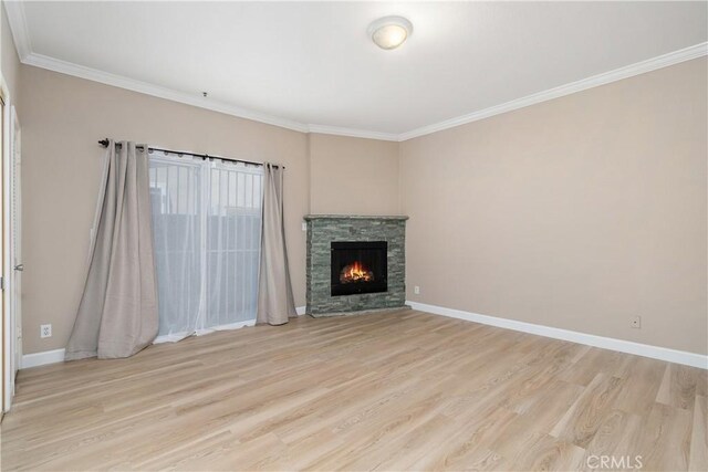 14853 Hartsook St Unit 106, Sherman Oaks, CA 91403 - unfurnished living room with light wood-type flooring, crown molding, and a fireplace