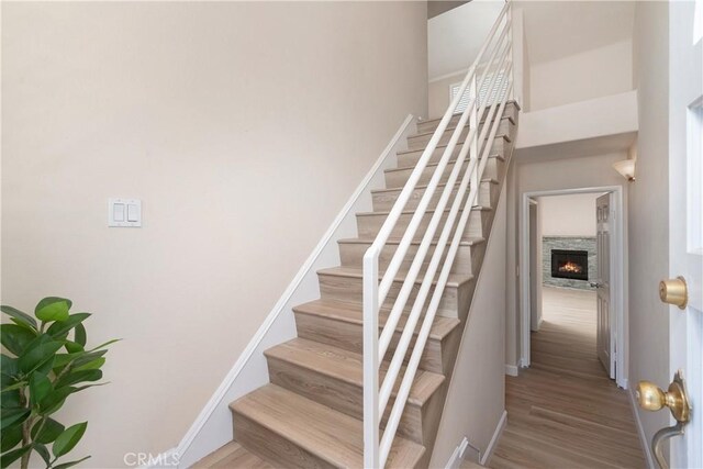 14853 Hartsook St Unit 106, Sherman Oaks, CA 91403 - staircase with wood finished floors and a fireplace