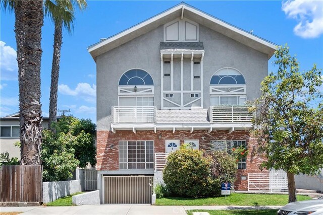 14853 Hartsook St Unit 106, Sherman Oaks, CA 91403 - view of front of house with brick siding, stucco siding, driveway, and a garage