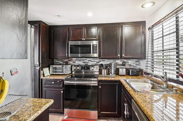 1527 Apache Dr Unit B, Chula Vista, CA 91910 - kitchen featuring stainless steel appliances, tasteful backsplash, dark brown cabinetry, recessed lighting, and light stone countertops