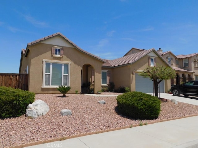 10947 Mesa Linda St, Victorville, CA 92392 - view of front of house featuring stucco siding, an attached garage, concrete driveway, and a tiled roof