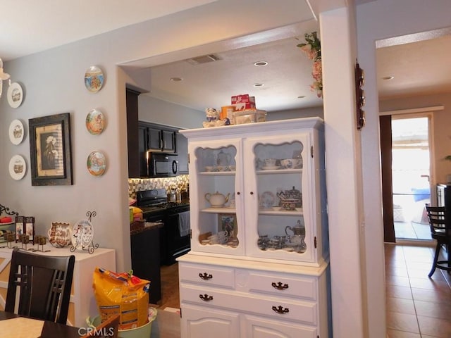 10947 Mesa Linda St, Victorville, CA 92392 - kitchen featuring black appliances, tasteful backsplash, white cabinetry, and tile patterned flooring