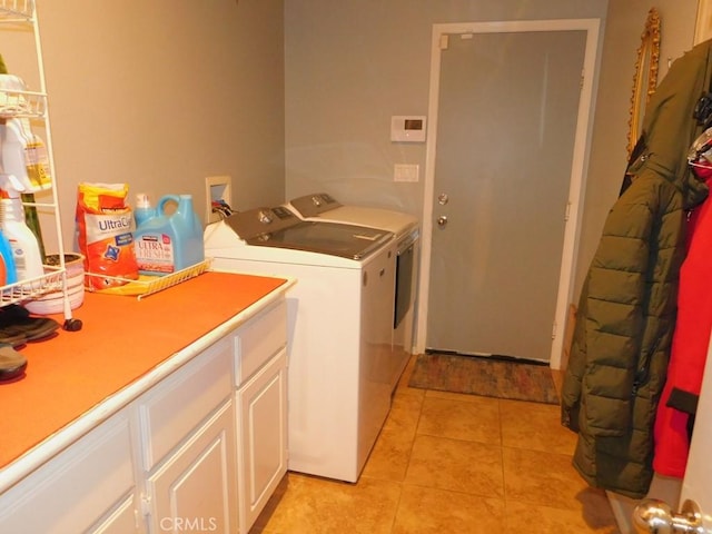 10947 Mesa Linda St, Victorville, CA 92392 - washroom featuring cabinet space, washer and clothes dryer, and light tile patterned flooring