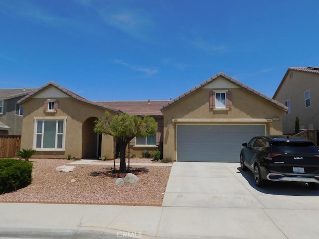 10947 Mesa Linda St, Victorville, CA 92392 - view of front of home featuring driveway, a garage, stucco siding, and a tiled roof