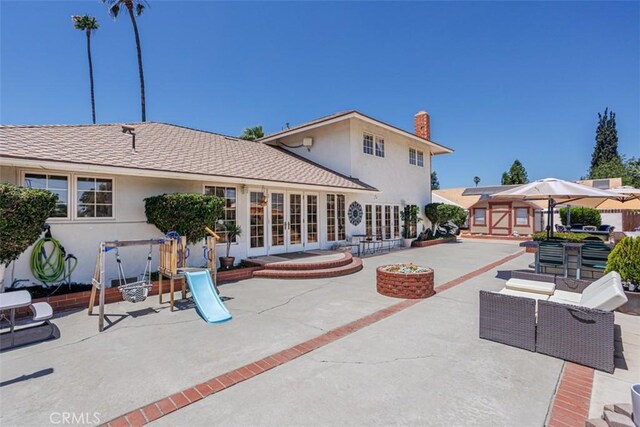 2001 Cypress Point Dr, Corona, CA 92882 - back of house featuring french doors, a patio, stucco siding, and a chimney
