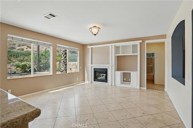 31868 Birchwood Dr, Lake Elsinore, CA 92532 - unfurnished living room featuring light tile patterned floors, a tile fireplace, and arched walkways